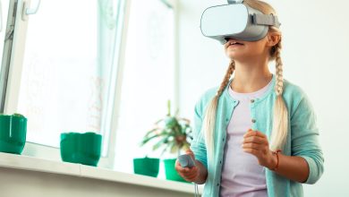Impressed schoolgirl playing virtual games at school