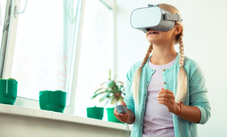 Impressed schoolgirl playing virtual games at school