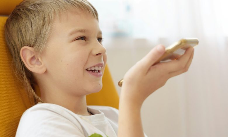 Boy makes voice search in smartphone