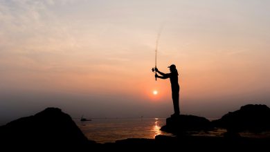 Silhouette of a man throwing a fishing rod